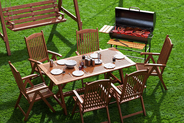 Elegant Outdoor Dining Setup Featuring Barbecue Grill on Lush Lawn