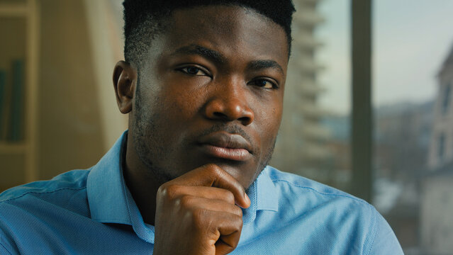 Head shot African American man ethnic thoughtful businessman think hold hand on chin doubt decision challenge solving business idea looking at camera nod head decide solution accept strategy support