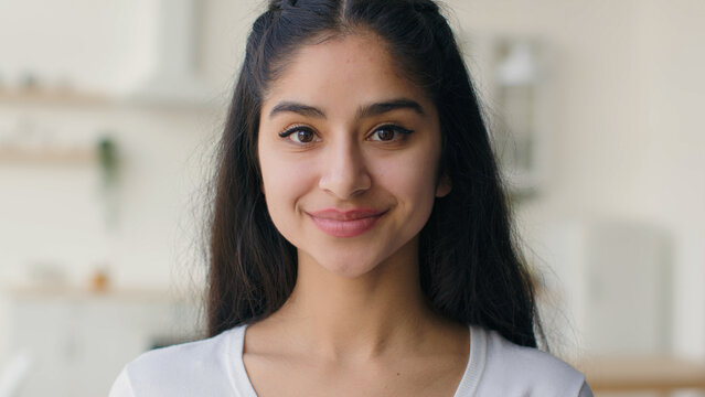Close up face woman multiethnic indian arabian homeowner businesswoman student girl with healthy smooth skin natural beauty make-up charming portrait joyful lady smiling female head shot in kitchen
