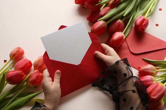 Girl holding an empty envelope with space for text, concept Happy Mother's Day, Happy Valentine's Day
