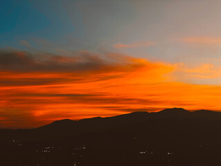 Beautiful sunset with orange sky and huge cloud seen from the Manrique neighborhood. Medellin, Antioquia, Colombia.