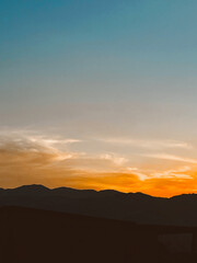 Beautiful sunset with orange sky and huge cloud seen from the Manrique neighborhood. Medellin, Antioquia, Colombia.