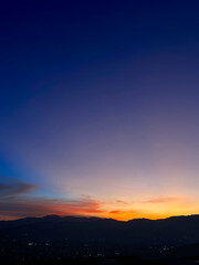 Colorful sunset with blue and orange sky. View of the city of Medellin.