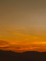 Beautiful sunset with orange sky and huge cloud seen from the Manrique neighborhood. Medellin, Antioquia, Colombia.