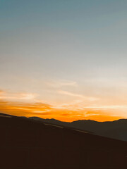 Beautiful sunset with orange sky and huge cloud seen from the Manrique neighborhood. Medellin, Antioquia, Colombia.