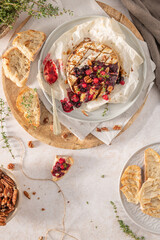 Baked or fried grilled Camembert or brie cheese with berry sauce or jam. Gourmet traditional Breakfast close up.