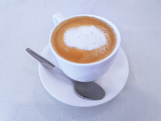 White cup of espresso coffee on background.
