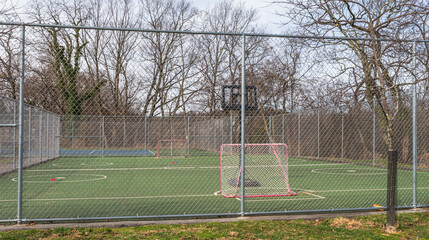 A park in the Swisshelm Park neighborhood with a fenced in area for hockey and basketball in...