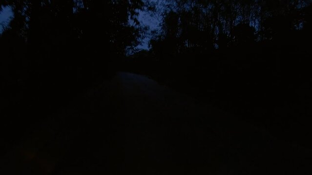 January 12, 2024 - Chalong, Phuket Thailand. Driving at night through dimly lit rural areas outside the tourist areas of Phuket.