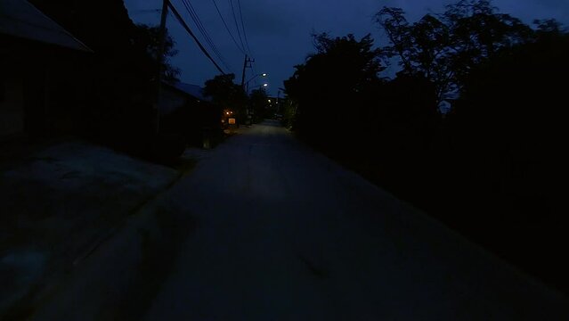 January 12, 2024 - Chalong, Phuket Thailand. Driving at night through dimly lit rural areas outside the tourist areas of Phuket.