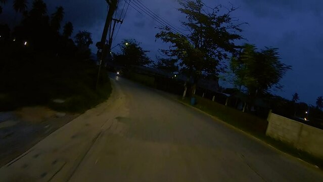 January 12, 2024 - Chalong, Phuket Thailand. Driving at night through dimly lit rural areas outside the tourist areas of Phuket.