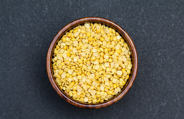 Toor dal or arhar dal in a wooden bowl top view 