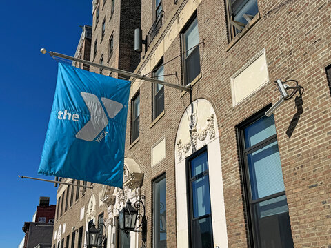Flag atop the entrance to a YMCA branch in Brooklyn, NY.