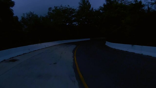 January 12, 2024 - Chalong, Phuket Thailand. Driving at night through dimly lit rural areas outside the tourist areas of Phuket.