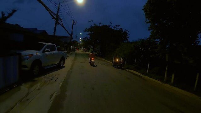 January 12, 2024 - Chalong, Phuket Thailand. Driving at night through dimly lit rural areas outside the tourist areas of Phuket.