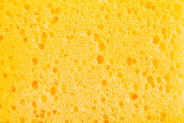 Yellow porous cleaning sponge texture or background - obrazy, fototapety, plakaty