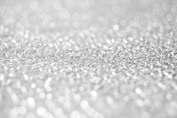 Silver white de focused sparkle glitter texture close up as background 
