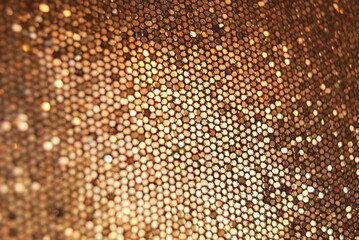 Golden overlap sequins fabric texture close up as background