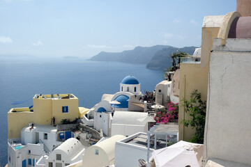 Aerial view of Oia town on the rocky shores of Santorini island - obrazy, fototapety, plakaty