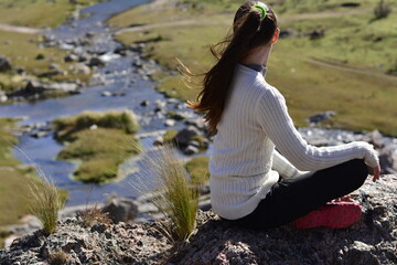 person sitting on a rock
