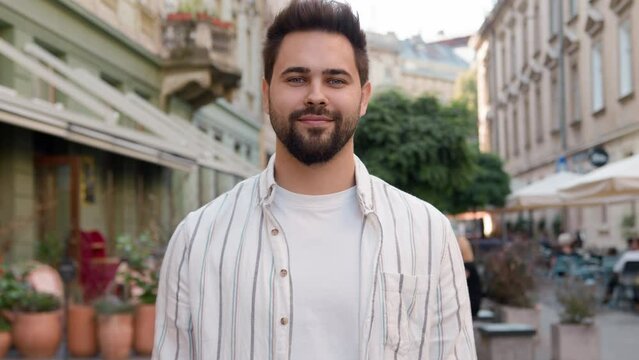Successful handsome Caucasian European man young confident guy businessman beckon symbol sign smiling street city outside invite welcome cheerful friendly male greeting gesturing join coming call up