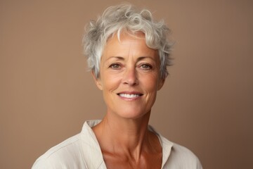 Portrait of a happy senior woman with short grey hair looking at camera