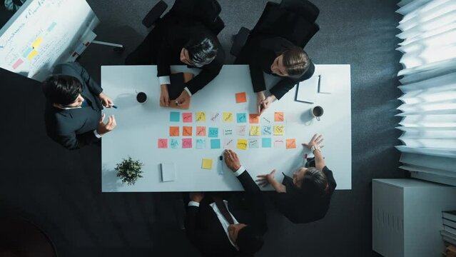 Top down ariel view of professional project manager present idea while putting together and clapping hand to celebrate successful strategy at meeting room. Show unity, love, teamwork. Directorate.
