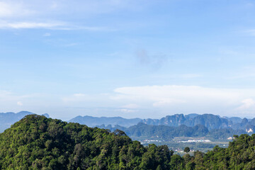 Fototapeta na wymiar Thailand, Krabi province landscape. View from Tiger Cave Temple (Wat Tham Suea). Blue sky and green jungles limestone mountains at the bottom.