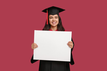 Happy female graduating student with blank poster on red background