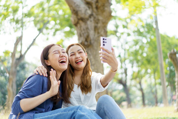 Women relaxing together at park.