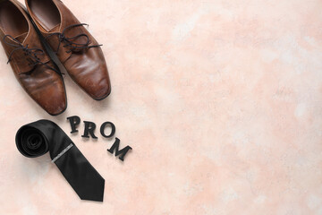 Word PROM with tie and male shoes on beige grunge background