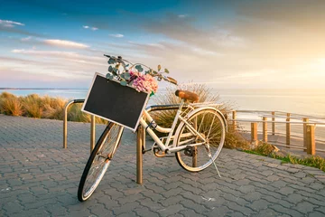 Foto auf Acrylglas Vintage bicycle with text banner frame on a steering wheel parked near the beach at sunset time © myphotobank.com.au