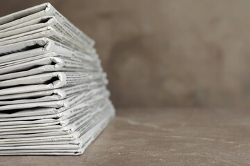 Stack of newspapers on marble table, closeup. Journalist's work - obrazy, fototapety, plakaty