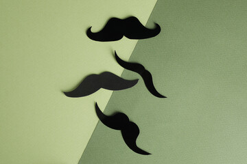 Fake paper mustaches on color background, flat lay
