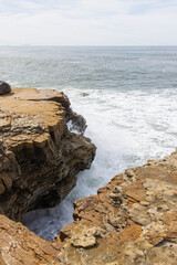 Waves breaking and cliffs on the west coast, San Diego, California