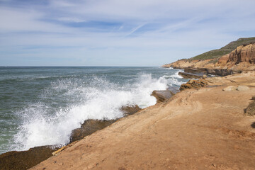 Fototapeta na wymiar Waves breaking on cliffs, San Diego, California