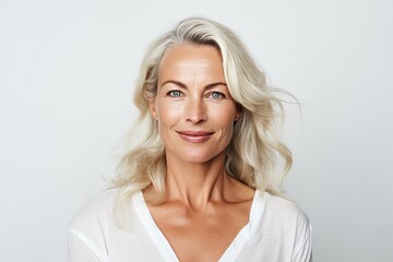 Portrait of a beautiful mature woman with blond hair. Studio shot.