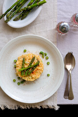 Scrambled eggs (Eggs Argentul) on a rustic table setting with a linen tablecloth, captured in an overhead portrait mode shot