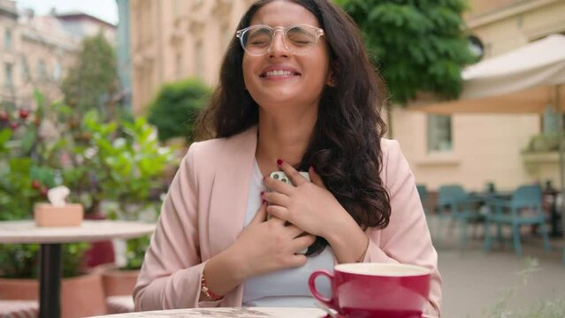 Happy Excited Smiling Indian Arabian Ethnic Woman Female Girl Celebrating Success Read Great News Mobile Phone Outside City Street Cafe. Lottery Win Express Candid Emotion Victory Triumph Celebration