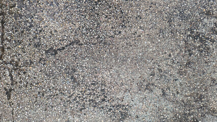 Top view of old gray cement floor with gravel stone. Concrete floor with moisture stains, lichens...
