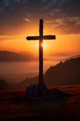 Divine Silence: A Weathered Wooden Cross Silhouetted Against a Stunning Sunset Over a Tranquil Landscape