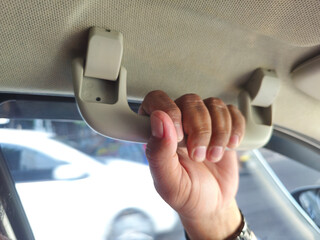 close up of hand hold on roof car hand grip