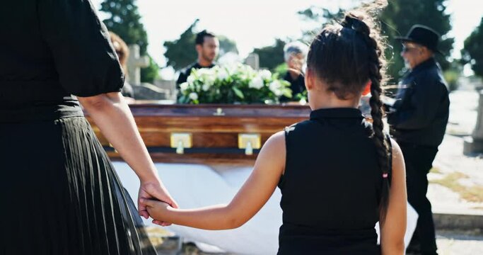 Parent, holding hands or child in funeral with family for healing or burial for respect or death. Back, depressed people or sad kid in cemetery for grief, loss or mourning with mother for support