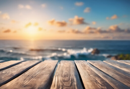 Wooden deck overlooking a blurred ocean sunset, serene nature background.