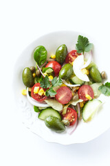 Healthy Salad with Green Olives, Baby Spinach, Cucumber, Cherry Tomatoes and Capers. Bright background. Close up.	
