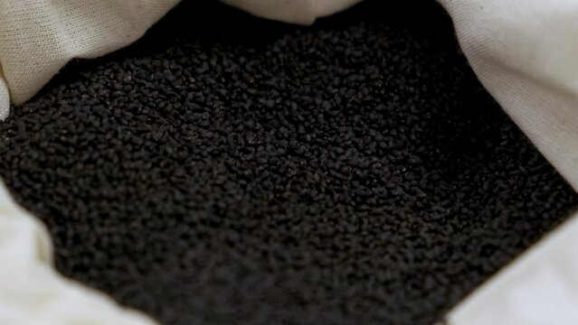 Full bag of black basil seeds, close-up shallow focus