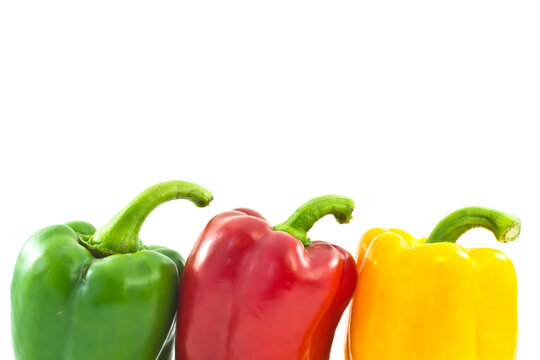 Red, yellow and green bell peppers isolated on the white background