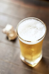 Glass of beer on wooden background. Copy space.	