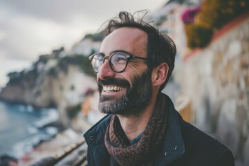 Portrait of a handsome bearded man with glasses and a scarf. - obrazy, fototapety, plakaty
