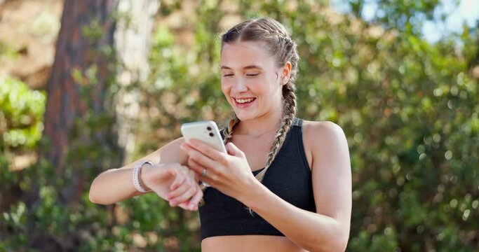 Athlete, exercise and phone with smart watch in nature for workout, heart rate or tracking time for run. Woman, breathe and technology outdoors for sports, fitness and check for progress in forest